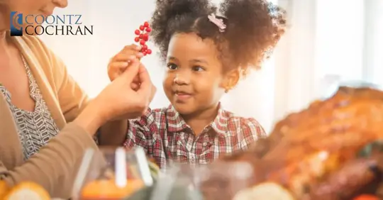 child and guardian having holiday dinner